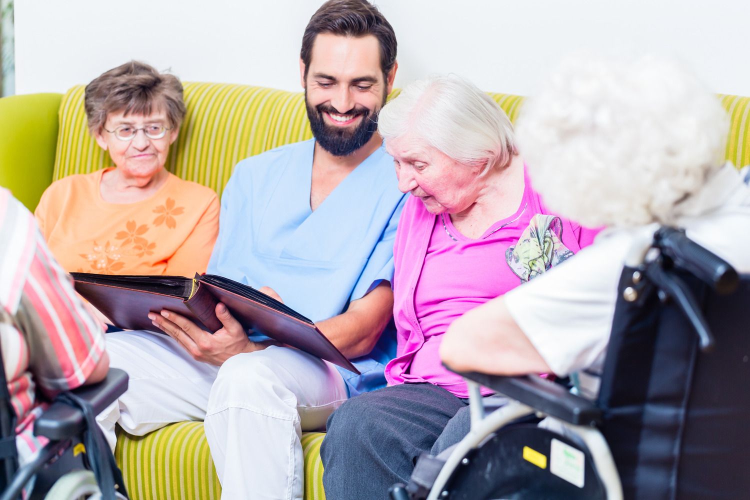 Carer sat with two elderly people